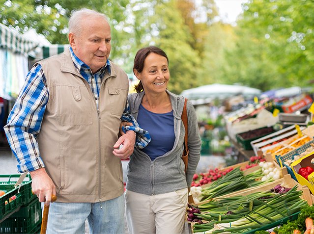 Senior man with caregiver shopping